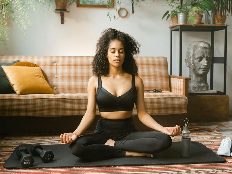 Close up of a focused woman practicing yoga indoors.